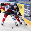 MINSK, BELARUS - MAY 16: Finland's Olli Jokinen #12 and Switzerland's Dean Kukan #34 battle for the puck during preliminary round action at the 2014 IIHF Ice Hockey World Championship. (Photo by Andre Ringuette/HHOF-IIHF Images)